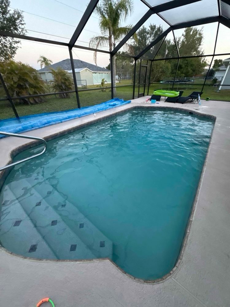 A screened-in Southwest Florida pool serviced by H2oPro, water clear to the bottom step